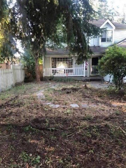 Bare, torn-up front yard before the project